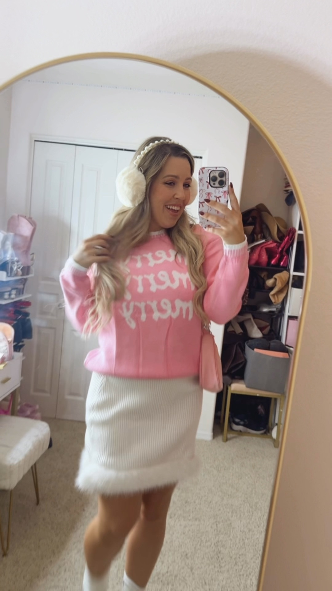 Pink holiday sweater
Holiday sweater
White skirt with feather trim
Holiday outfit
Festive outfits 
White pearl earmuffs 

#LTKSeasonal #LTKootd #LTKHoliday