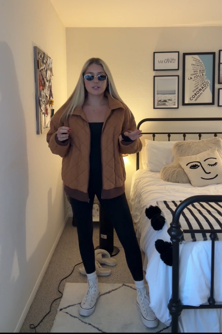 Black onesie outfit with quilted jacket & crew socks with high top converse 