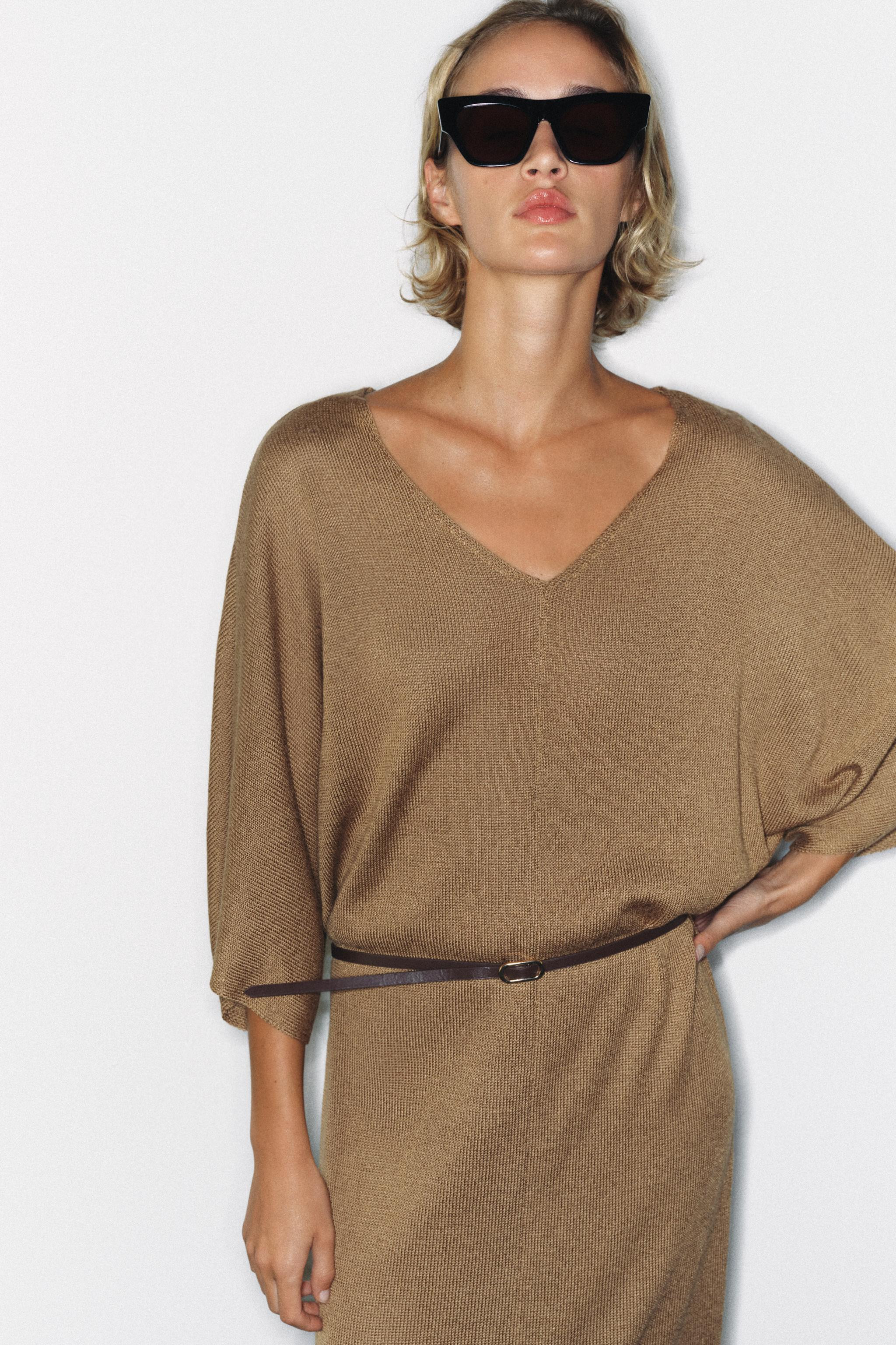 V-neck midi dress featuring wide, long sleeves, a matching belt detail, and a back slit at the he... | Zara US