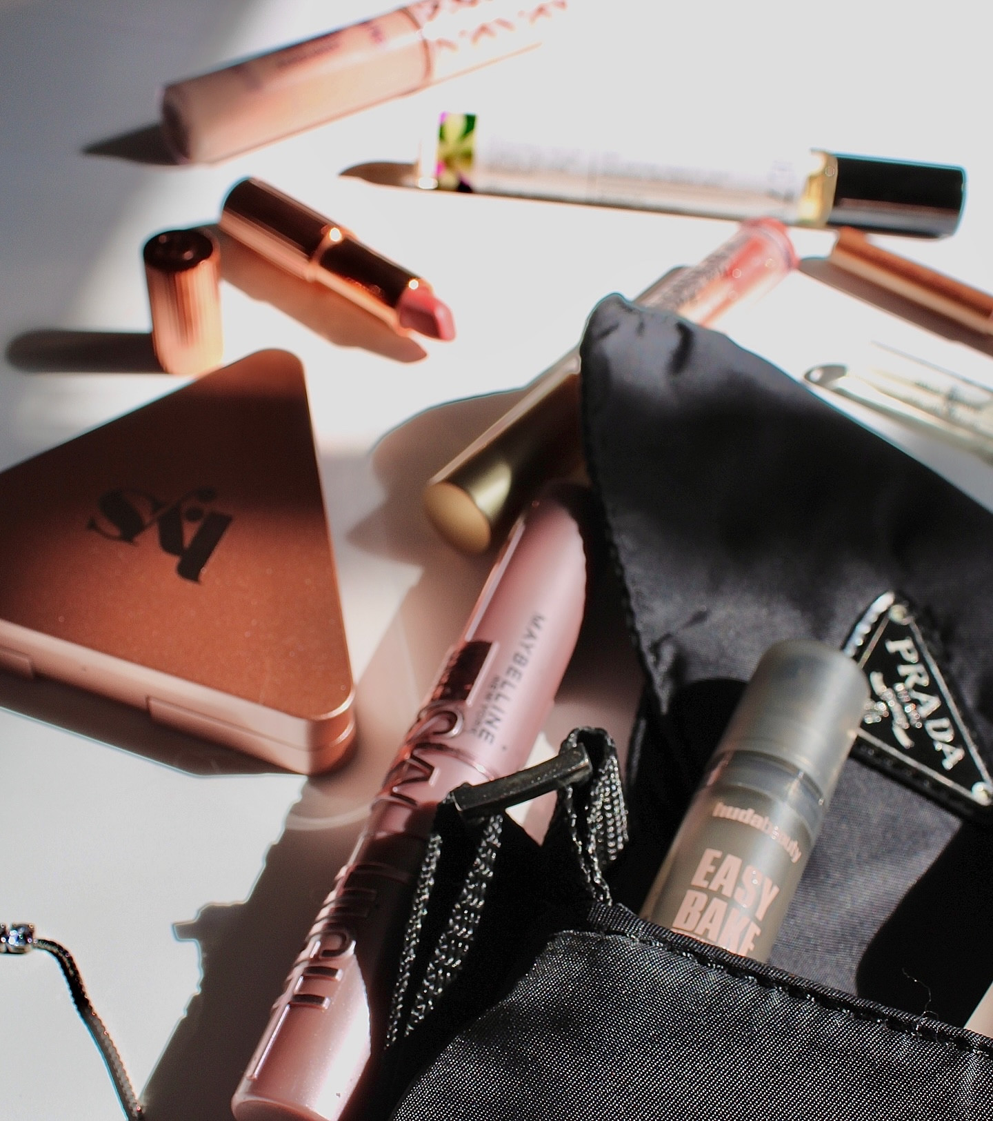 My favorite kind of chaos: Everyday Beauty Essentials❕💅 

I love a good high-low mix in my makeup bag! 
The tiny Prada pouch is somehow holding all of my essentials—the ultimate travel companion🧳 

Drugstore Hero: That Maybelline Sky High mascara is a game changer.
Lip Combo: Nothing beats a Charlotte Tilbury liner/lipstick base with a swipe of Too Faced Lip Injection gloss.
Calming Scent: Obsessed with the Vanilla Woods travel size for stressful days. Noyz brand new fragrance "ONLY HUMAN" pairs elegantly with Vanilla Woods!🌬️
Huda Beauty Easy Bake: for setting that glow without drying out your skin🌟
LYS Beauty: Higher standard satin matte cream blush, high-pigment, non-greasy, and buildable. Satin-matte finish.
Fenty Beauty: pro Filt'r silky primer, Instantly hydrates the skin, keeps it comfortable all day, and ensures foundation glides on smoothly without settling into dry patches.

@toofaced 
@charlottetilbury 
@the7virtues 
@maybelline 
@fentybeauty 
@lysbeautyofficial 
@tartecosmetics 
@hudabeauty 
@noyz_official 
@prada

#sephora #makeuptutorial #whatsinmybag #pradapurse #elegant #luxbeauty #fentybeauty #charlottetilburymakeup #noyz #perfume #vanillawoods #the7virtues #toofaced #lipinjection #lipgloss #skyhighmascara #maybelline #drugstoremakeup #beautytips #productphotography #hudabeauty #lysbeauty #tarteshapetape #cultfavorite #trendingmakeup #explorepage✨ #aesthetic #sunlight #productlays #ugc