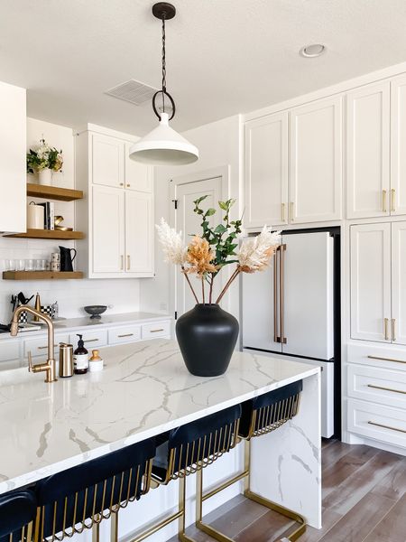 Kitchen decor and essentials! Love our white kitchen and we changed the faucet to this Brizo brass faucet with an angled spout. We love the look and it goes with our brass cabinet hardware. Also linking our leather counter stools, pendant lights, oversized black vase and winter decor  

#LTKhome #LTKsalealert #LTKSeasonal