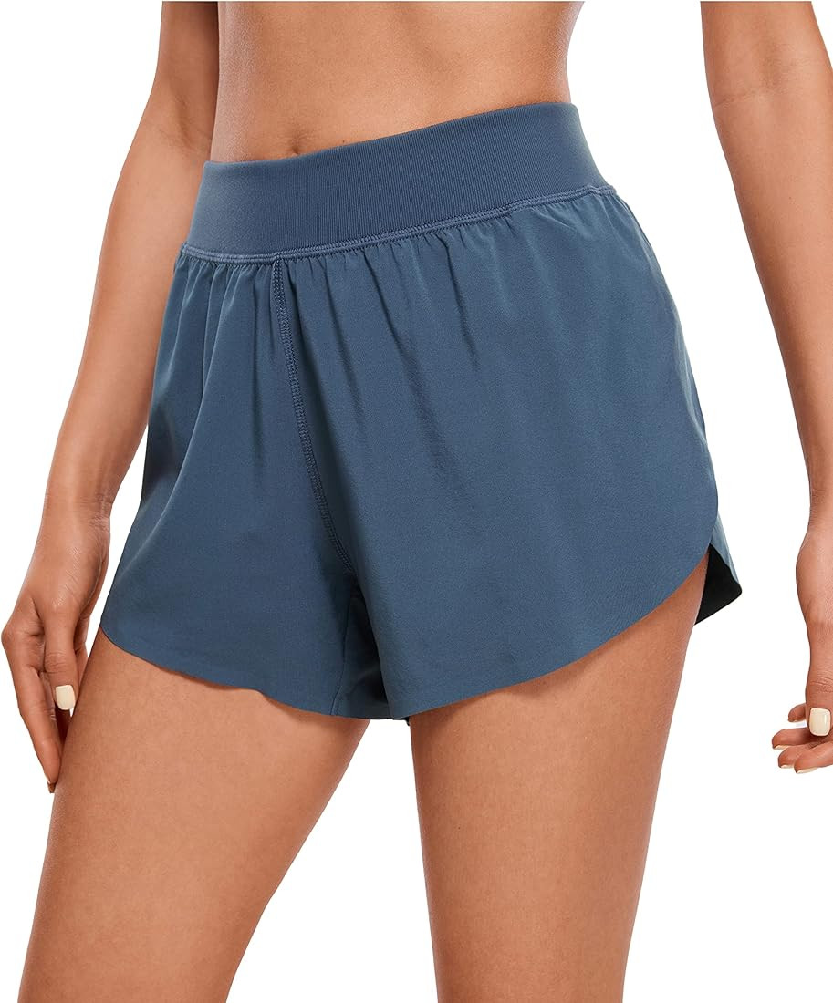 CRZ YOGA Mid Waisted Dolphin Athletic Shorts for Women Lightweight High Split Gym Workout Shorts ... | Amazon (US)