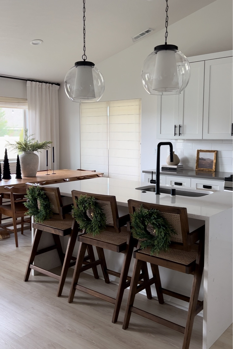 Christmas wreath, bar counter stools, glass with white shade pendant lights kitchen  

#LTKSeasonal #LTKhome #LTKHoliday