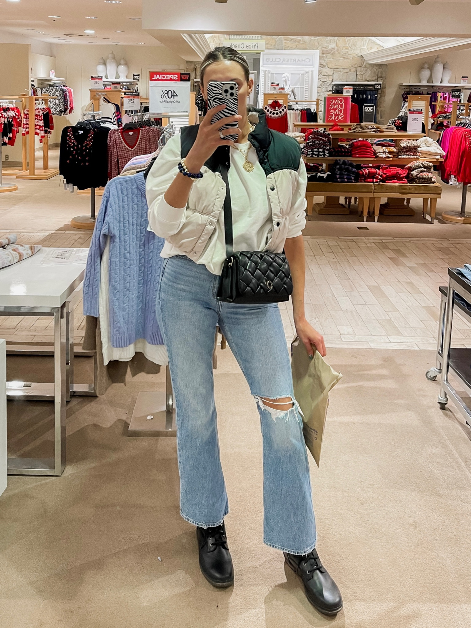 Outfit idea for fall and winter - high waisted flare jeans, color block puffer vest, oversized sweatshirt tucked under, quilted crossbody bag, waterproof ugg boots 

#LTKunder50 #LTKstyletip #LTKunder100