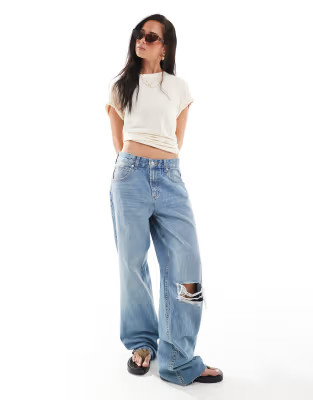 ASOS DESIGN low rise baggy jeans with rips in mid blue | ASOS (Global)