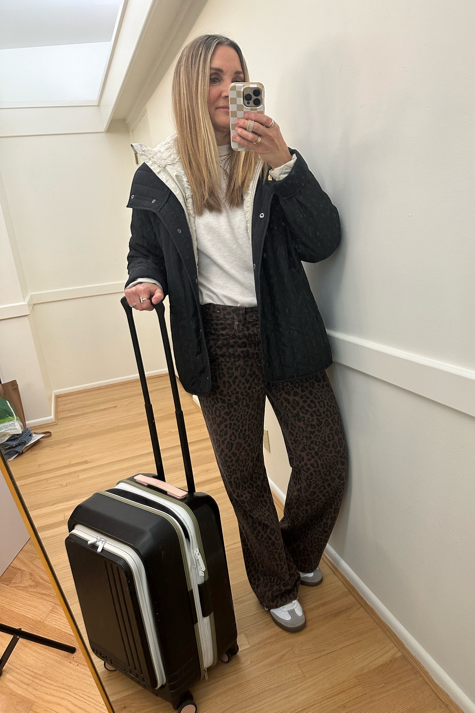 Airport outfit! Madewell leopard baggy jeans with Splendid pullover and quilted jacket. Layered over Columbia hooded quilted coat. Adidas Samba, Roam carryon luggage, travel outfit 

#LTKTravel #LTKStyleTip #LTKOver40