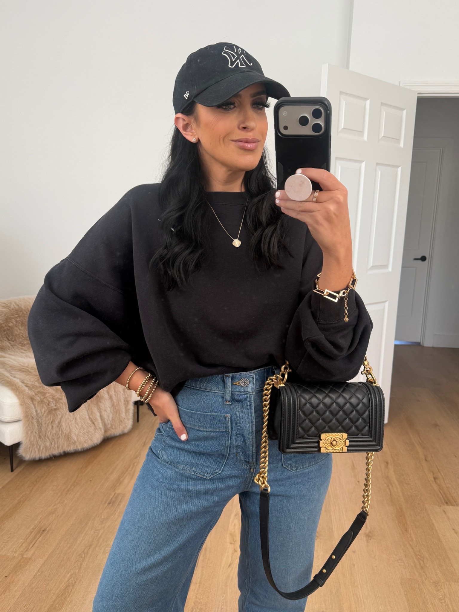 SPANXshape™ Authentic 360 Easy Flare Jeans with Patch Pockets wearing size medium. Nike Sportswear Phoenix Fleece Women's Over-Oversized Crew-Neck Sweatshirt wearing size small. 