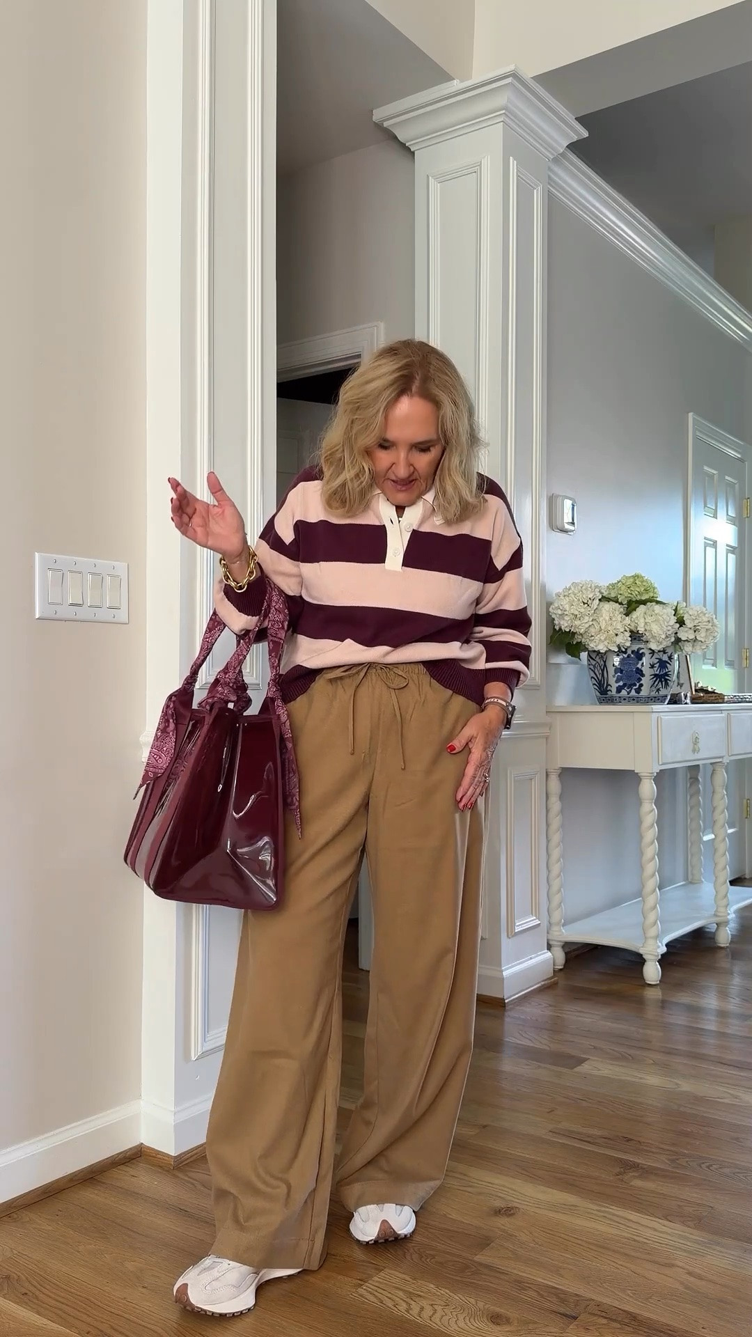 The rugby stripes and little ruffle collar are such a fun combination, and that burgundy tote is a nice touch! I’m wearing a small petite in the top and a medium in the pants.