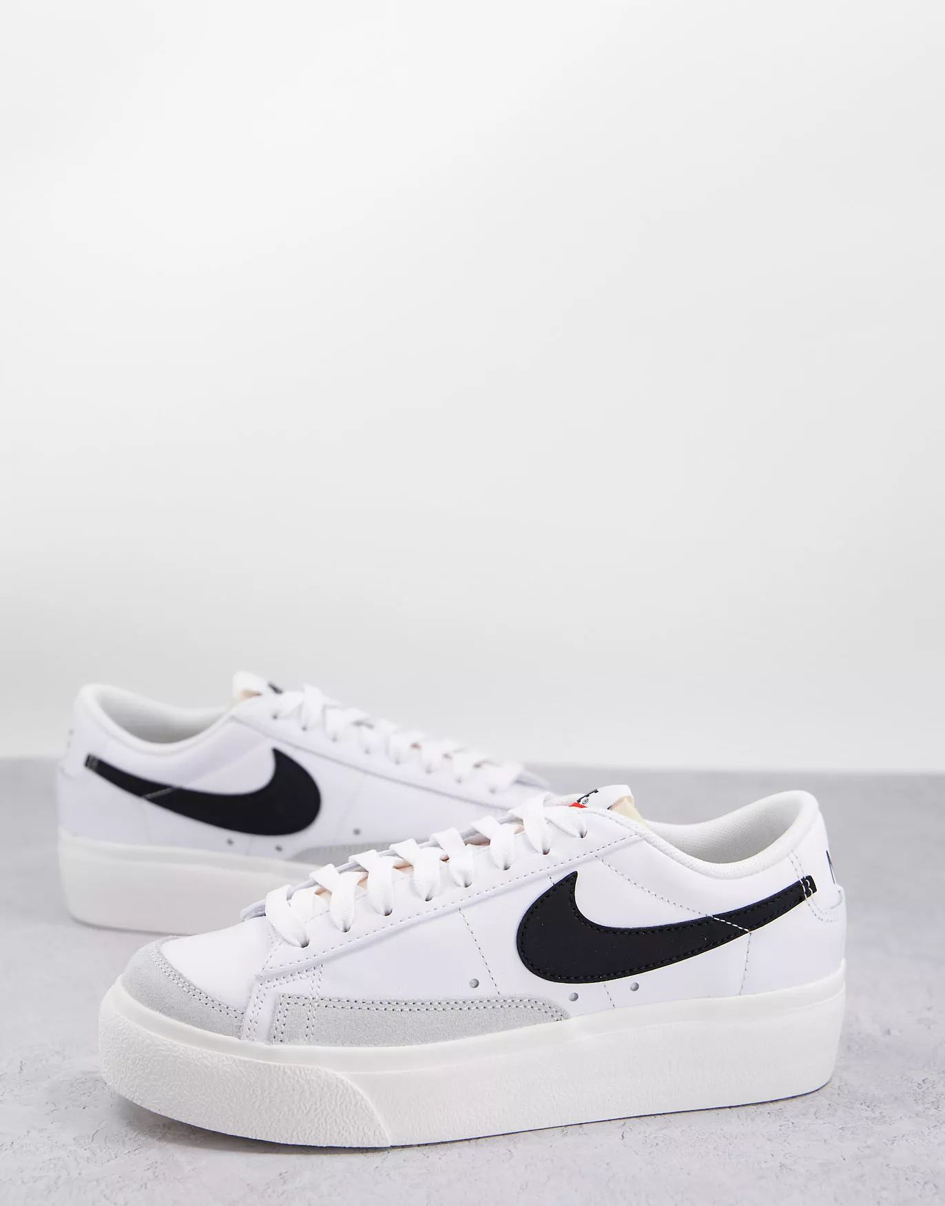 Nike Blazer Low Platform sneakers in white and black | ASOS (Global)