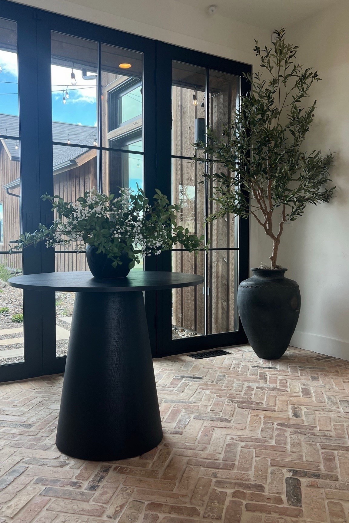 If you want your entryway to feel alive and styled, add greenery. A small round entryway table paired with an olive jug, faux tree, and baby’s breath stems makes the foyer feel layered and intentional.

This is such an easy way to add height and warmth without overwhelming the space.

Follow my shop @rushtonhome on the @shop.LTK app to shop this post and get my exclusive app-only content!

Don’t forget to turn on post notifications using the 🔔 to get first dibs!

Follow @rushtonhome on Instagram and Pinterest for more home decor inspiration and affordable home finds!

Are you looking for anything home related? You’re in the right place! At Rushton Home, I do: home decor, living room, bedroom, affordable, walmart, target, amazon, wayfair, new arrivals, winter decor, spring decor, fall decor, fall finds, summer decor, home decor refresh, studio mcgee x target, hearth and hand, magnolia, holiday decor, seasonal decor, dining room decor, bedroom decor, living room decor, affordable home decor, furniture, weekend deals, sale, on sale, pottery barn, kirklands, west elm, bench, foyer table, faux florals, rugs, couches, sofa, sectional, dresser, nightstand, night stand, end tables, lamps, art, wall art, etsy, pillows, blanket, interior design, interior styling, bedding, side tables, bed frame, tray, side table, throw pillows, look for less, designer dupe, budget decor, bar stools, counter stools, vase, ceramic pottery, budget, budget friendly, coffee table, dining chairs, cane, rattan, wood, white wash, rustic amazon home, arch, brass hardware, gold hardware, vintage, antique, european inspired, french country, back in stock

#LTKHome #LTKSaleAlert
