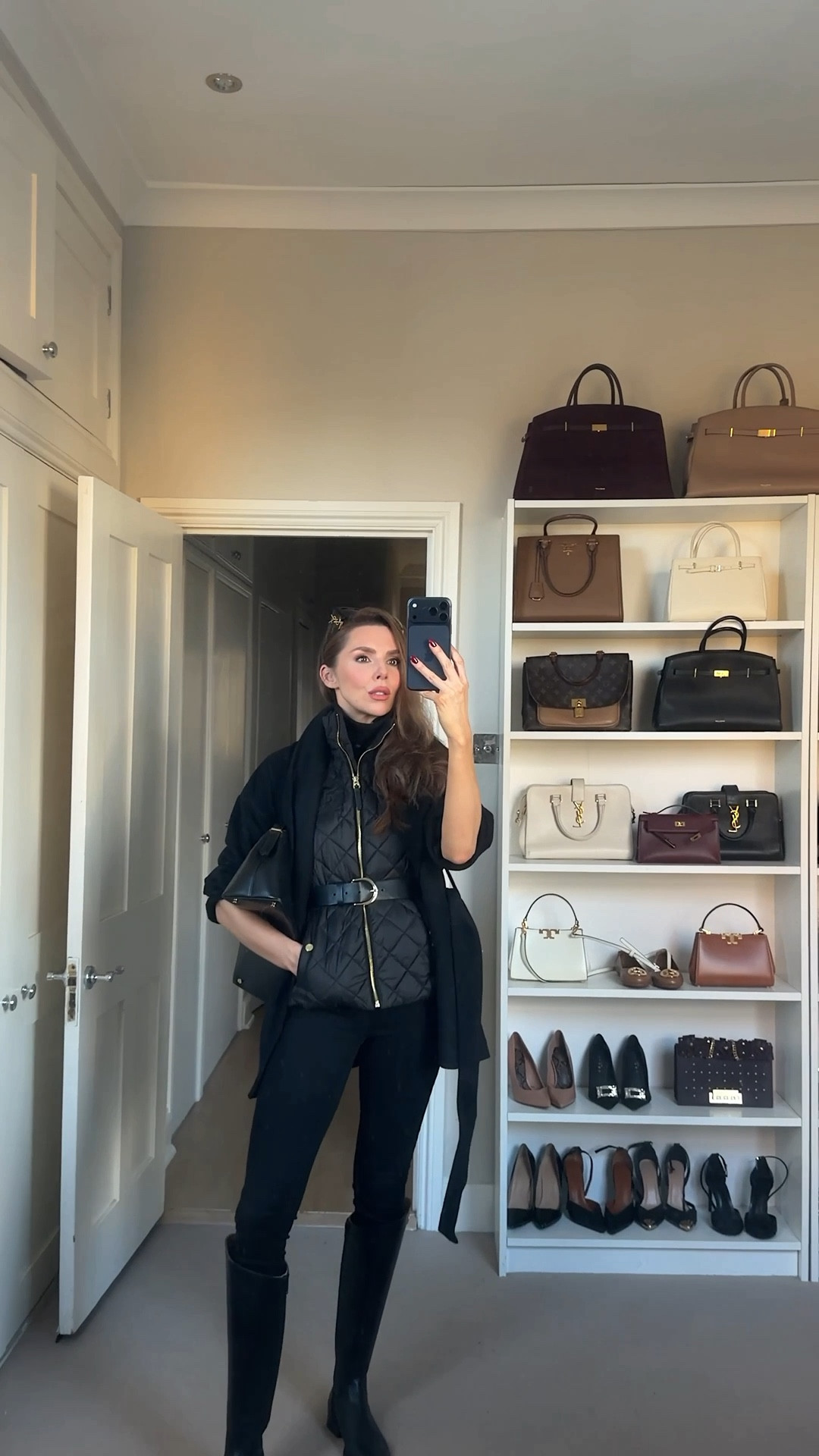 A black quilted gilet layered over a black sleeveless roll neck for a clean, polished base. Styled with a black wool jacket and a statement waist belt to create shape and that luxe winter look. Paired with classic black skinny jeans and sleek black knee-high boots. I accessorised with Saint Laurent sunglasses for a high-end touch and the Toteme T-Lock black clutch for a minimalist, elevated finish. A monochrome all-black outfit that’s perfect for winter styling, school-run chic, city walks, and everyday luxury looks.

#LTKeurope #LTKwinter #LTKuk