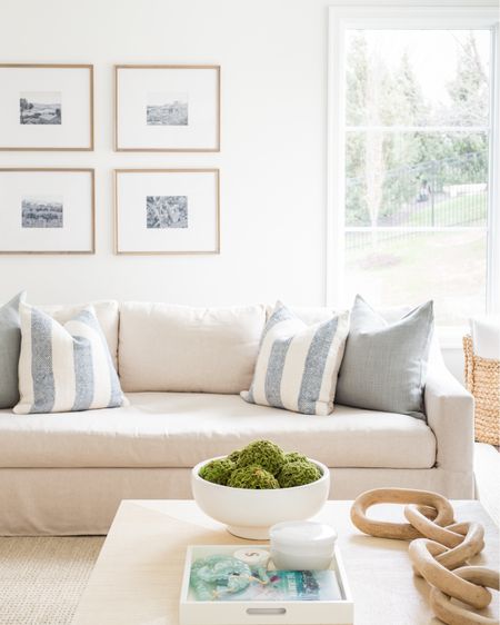 Our Omaha spring living room with linen sofas, light leather chairs, raffia coffee table, gallery wall frames, wood chain decor, blue striped pillows and faux moss balls in a larger ceramic bowl.
.
#ltkhome #ltksalealert #ltkseasonal #ltkstyletip #ltkfimdsunder50 #ltkfindsunder100

#LTKSeasonal #LTKsalealert #LTKhome