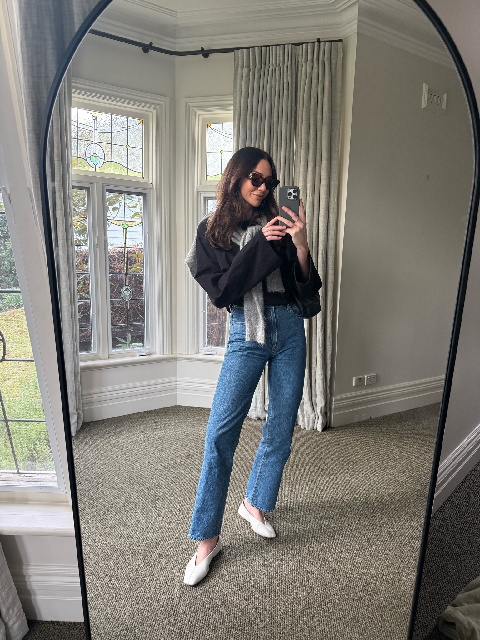 Casual elevated outfit 
Black long sleeve top with flare sleeves 
Grey mohair sweater 
Blue high rise straight leg jeans 
Off white leather ballet flats 
Loewe cat eye sunglasses

#LTKaustralia #LTKautumn #LTKstyletip