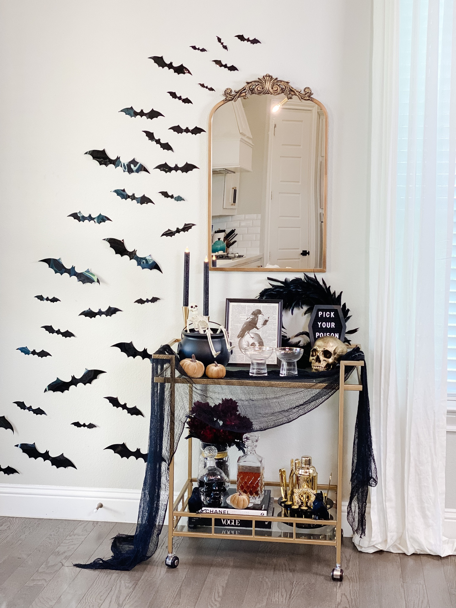 Halloween bar cart styling, amazon home, brass bar cart, ornate mirror, brass mirror, antique mirror, anthropology dupe, feather wreath, black, gold, print, bats, skull, pumpkin, decanter, cauldron, vase, florals, candy bowl, candles, candlesticks, moody, spooky. 

#LTKHalloween #LTKSeasonal #LTKhome