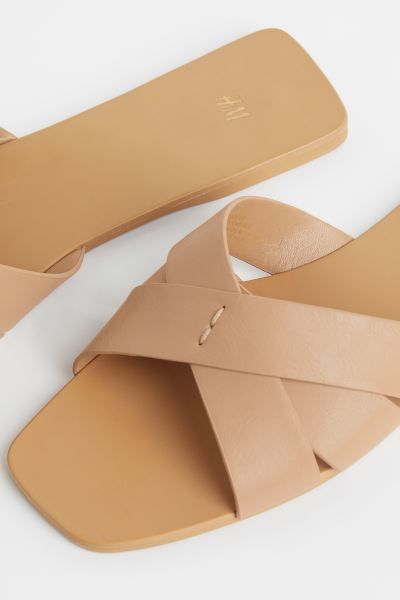 New ArrivalSlides in faux leather with wide, crossover foot straps and square toes. Faux leather ... | H&M (US + CA)