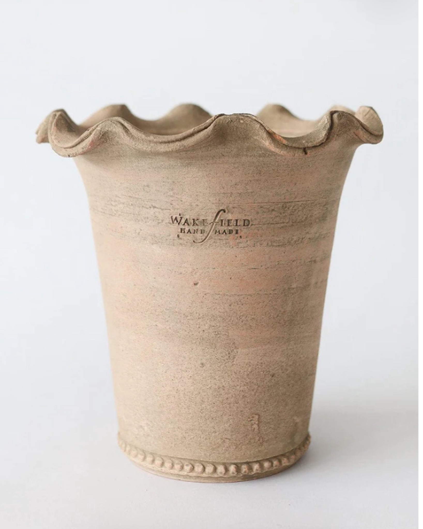 The ruffled design gives it a sweet detail with an aged look. Each plant pot is handcrafted and will vary slightly. NOT Frost Proof, store inside during winter months.

9" Tall x 8.5" Wide x 6.25" Opening
Clay
Indoor/Outdoor
Drainage Hole
Will Not Hold Water
6 lbs

#LTKSeasonal #LTKhome