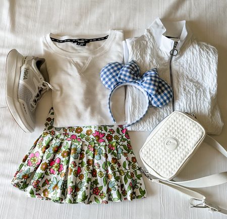 Disney Park outfit idea! 🎀 Take away the ears and you are ready for a pickleball match! 

I have the DKNY waffle knit t-shirts in two colors (white and blue)! 🤍💙 They will be my go to for the summer.

I absolutely LOVE my Smith and Quinn skort. This floral pattern is perfect for on and off the court.

Full zip white jacket and bag are Chervo [products not available to link]

#LTKfamily #LTKtravel #LTKActive