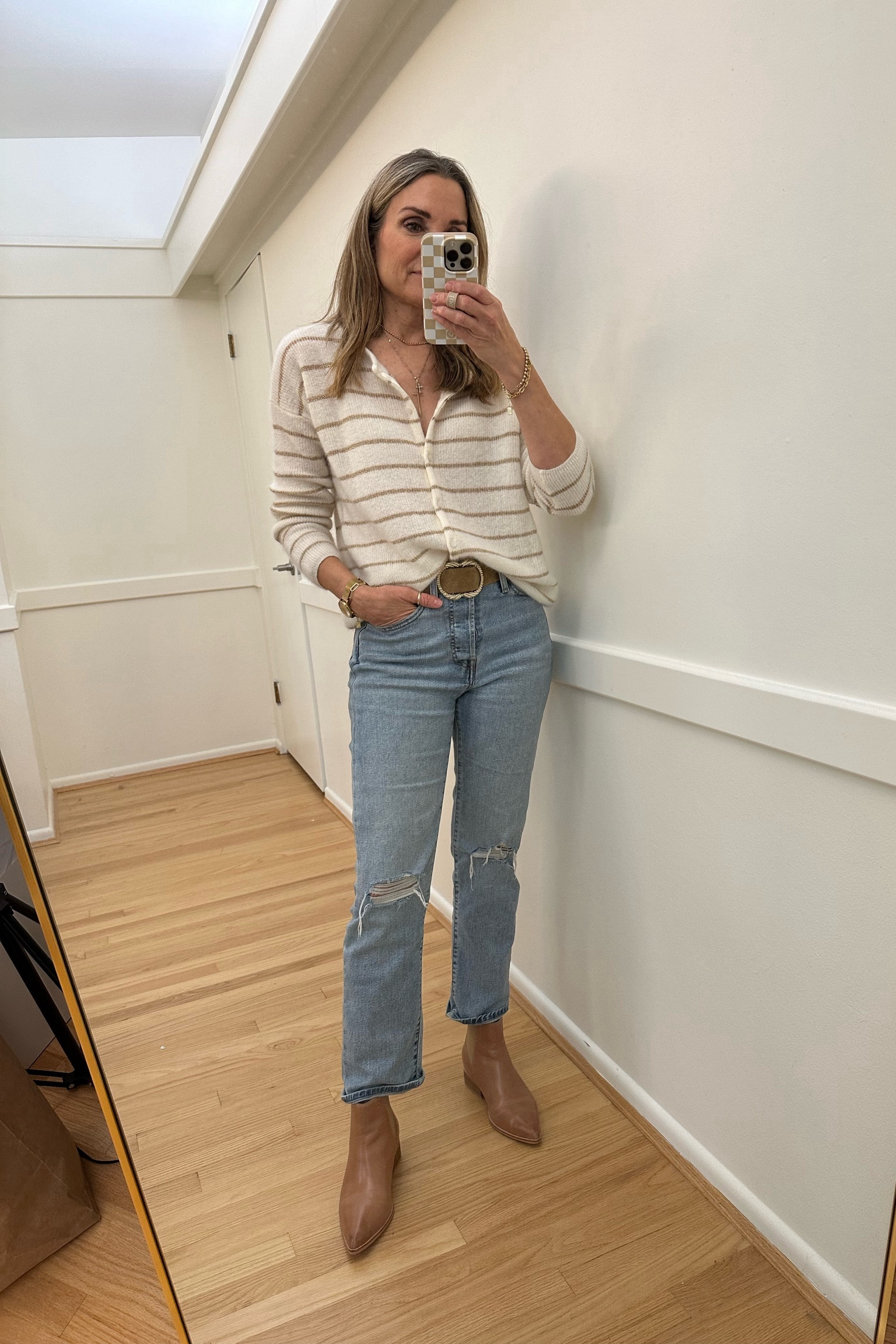 Cream and gold striped cardigan sweater with Levi’s wedgie jeans and Frankie4 camel booties. Love my beige Sezane belt too! Holiday outfit inspo  

#LTKover40 #LTKstyletip #LTKfindsunder100