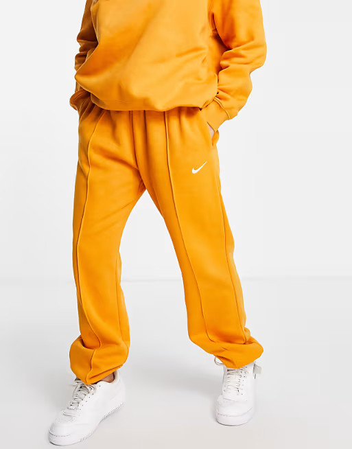 Nike Collection Fleece loose fit cuffed sweatpants in mustard | ASOS (Global)