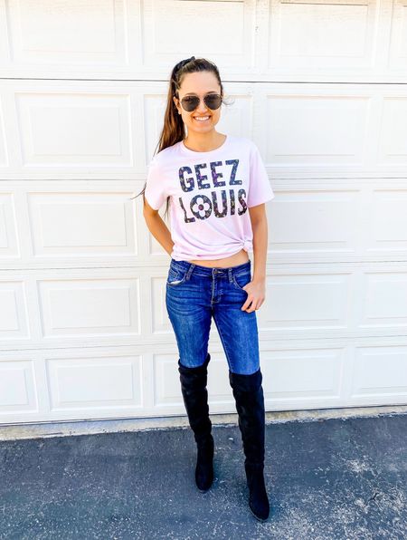 Geez Louis tshirt paired with blue jeans and black over the knee boots! 

#LTKfindsunder100 #LTKfindsunder50 #LTKstyletip