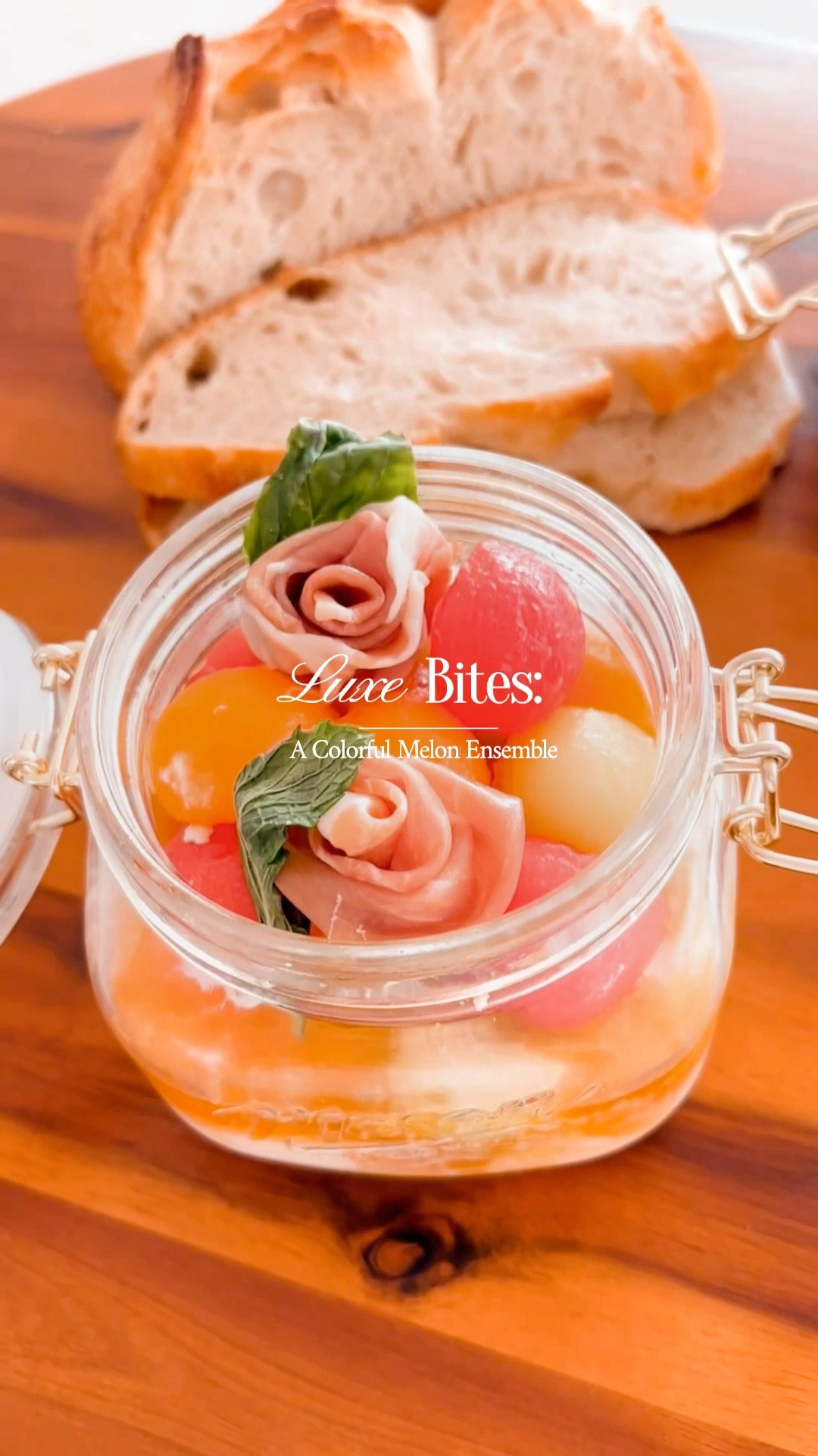 Savor the delightful blend of sweet cantaloupe, honeydew, and watermelon that come together in this unexpected but utterly delicious salad. It's an ideal choice for a leisurely picnic, or a convenient packed lunch, or offering a refreshingly appetizing experience. 
For this charming creation, you'll need:
- 1 melon bursting with flavor
- 1 honeydew that's a juicy delight
- 1 watermelon, ripe and juicy
- 4 creamy burrata cheese balls
- A handful each of fresh basil and mint leaves
- 6 slices of the finest Parma Ham
Elevate your salad with a zesty Honey Vinaigrette made from:
- ¼ cup of extra virgin oil
- 2 tablespoons of honey's golden goodness
- The juice of a vibrant lemon
- 1 tablespoon of white balsamic vinegar
- A pinch of Himalayan rose salt
Now, let the culinary adventure unfold:
1. Playfully deconstruct the burrata balls into your jar, turning them into a creamy base with the help of a fork.
2. With the finesse of an artist, scoop out colorful melon balls using a melon baller. Arrange them on the bed of burrata, creating a joyful medley of flavors.
3. Embrace your inner food artist and fashion prosciutto slices into dainty rose shapes. Crown each rosebud with a mint and basil leaf, adding a touch of natural elegance.
4. Just before the grand reveal, shower your masterpiece with the Honey Vinaigrette. This nectar of flavors harmonizes the elements, ensuring each bite is a delightful ensemble of tastes.
For the Honey Vinaigrette:
1. Gather your ingredients and let them mingle in a bowl. A simple stir brings together the dance of flavors, forming a vinaigrette that's both zingy and sweet.
2. Keep this “magic” potion in the cool embrace of your fridge until it's time to unveil its magic.
This salad isn't just a dish; it's an invitation to relish the joys of fresh ingredients, vibrant colors, and harmonious flavors. With every bite, you'll embark on a journey that's as delicious as it is elegant! 
