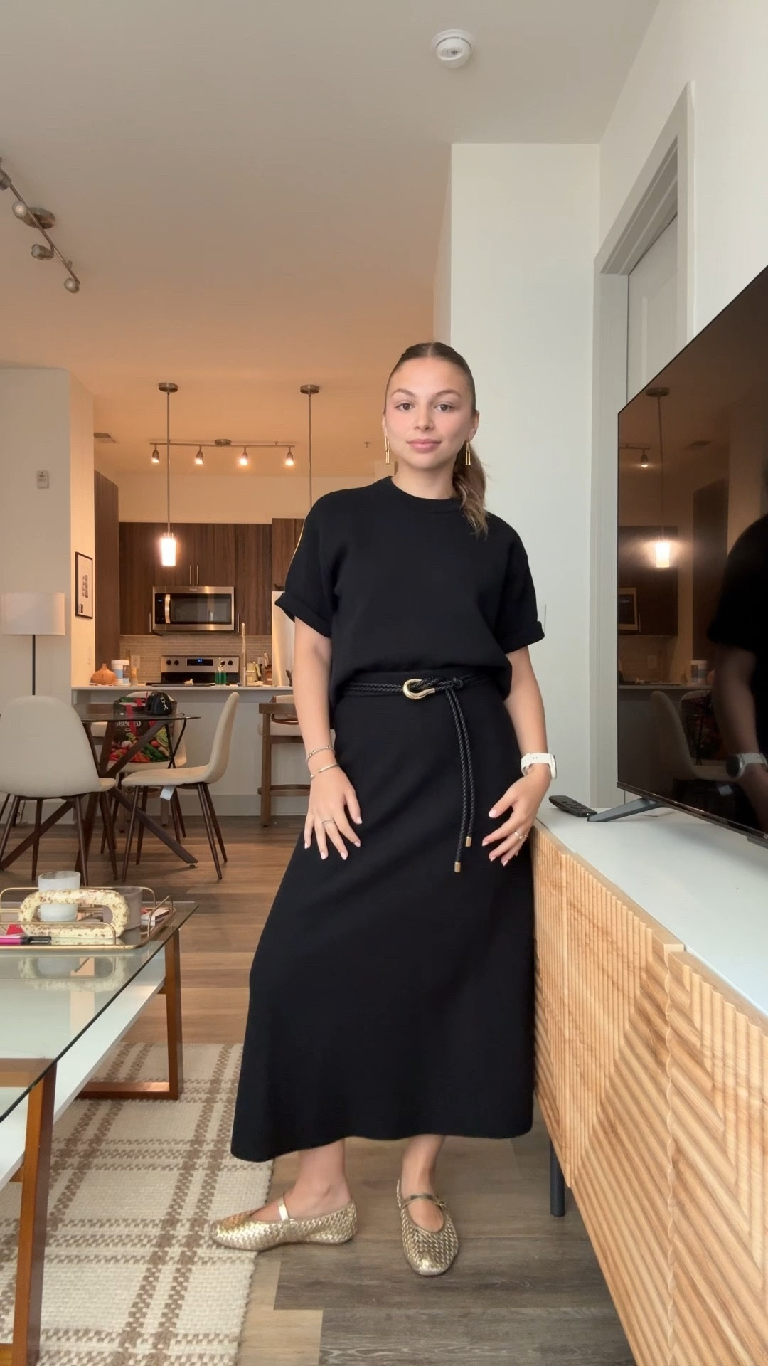 An all-black outfit that does it all. Pairing a simple tee with a belted skirt keeps it chic, while woven flats add comfort for everyday wear.

#LTKWorkwear #LTKPetite