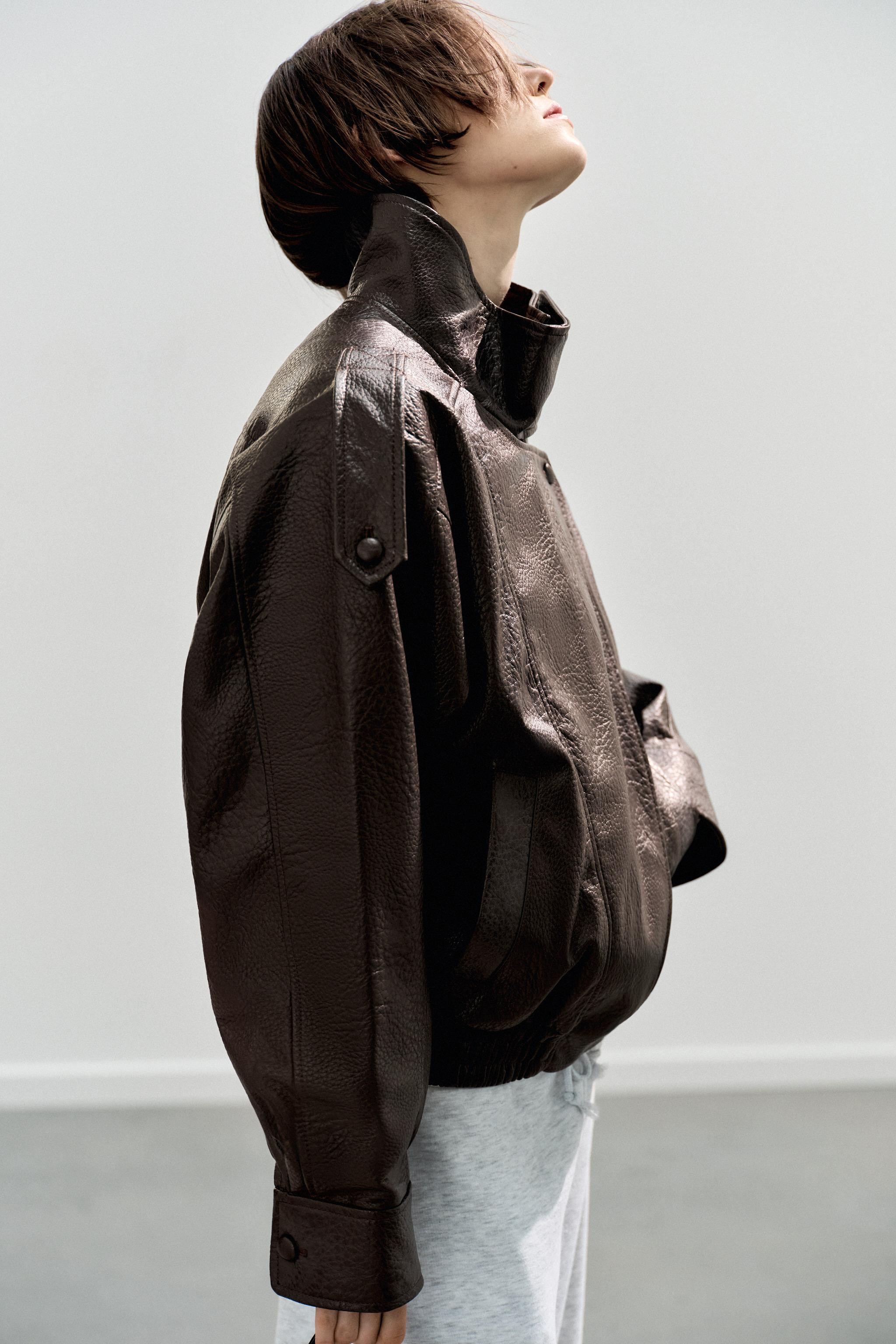 High collar jacket. Long sleeves finished in cuffs with shoulder tabs. Side pockets. Contrasting ... | Zara US