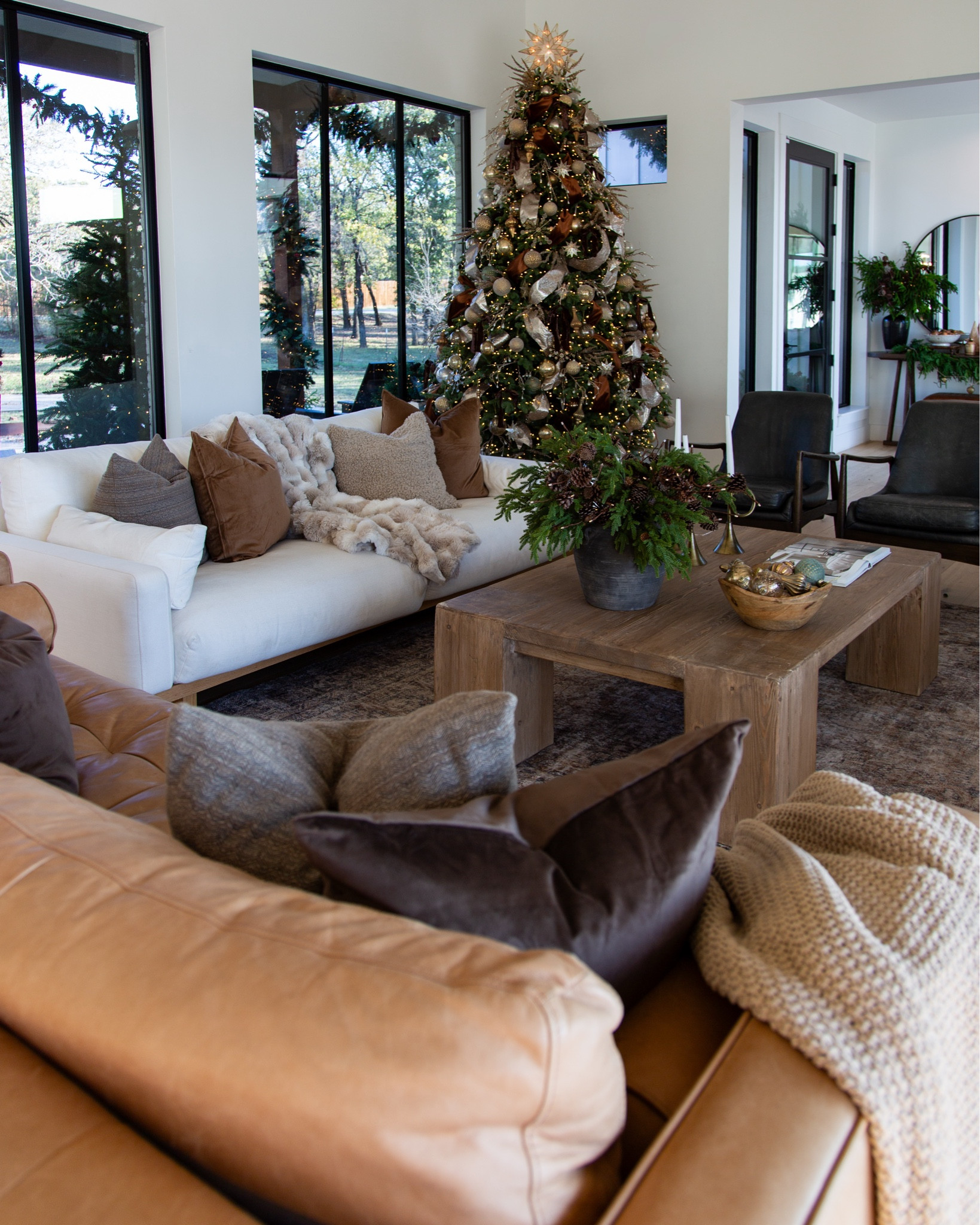 Holiday living room tour — where warm tones, soft textures, and twinkle lights make everything feel like home. This space is layered with neutral furniture, rich brown accents, vintage-look rugs and a heavily styled Christmas tree for that cozy-modern feel we live for in winter.

The Loloi Morgan Sunset/Ink rug (65% off!) anchors the room with depth and pattern — still one of my favorite “instant character” rugs. Our Castlery white sofa + leather sofa, paired with magnolia black leather chairs and the Eternity Modern coffee table, create the perfect mix of modern lines and organic warmth.

To soften the space, I added fur throws + textured pillows from Amazon, warm greenery, and a ribbon-heavy tree full of metallics and browns for a luxe but lived-in look. The goal: elegant + inviting, never too precious to sink into.

If you love a neutral, cozy Christmas home with timeless furniture and natural materials — everything is linked and shoppable.

cozy Christmas home, warm modern living room, neutral holiday decor, vintage style rug, Loloi Morgan Sunset Ink, Castlery sofa, Magnolia leather chairs, Eternity Modern coffee table, Amazon pillows and throws, Christmas tree styling


#LTKHoliday #LTKSaleAlert #LTKHome