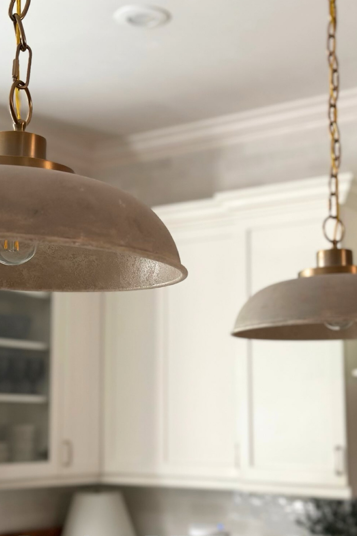 Before and after of this easy kitchen island pendant DIY. I needed to warm up this white kitchen and opted for an inexpensive kitchen project over spending $2400 more for the real Elliot version. 

I used what felt best in my kitchen since I could customize it, so this could easily be adapted to your homes tones. 

Several look alike options to recreate it over on my LTK!

#kitchenbeforeandafter #kitchenislandlighting #kitchenislanddesign #whitekitchencabinets #kitchenhack #kitchendiy