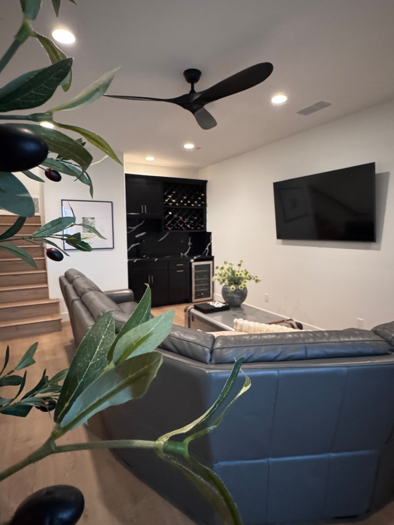 Bonus room | leather couch | botanicals | vase | wet bar | black | wood | tree 

#LTKHome #LTKstorytime #LTKdayinmylife