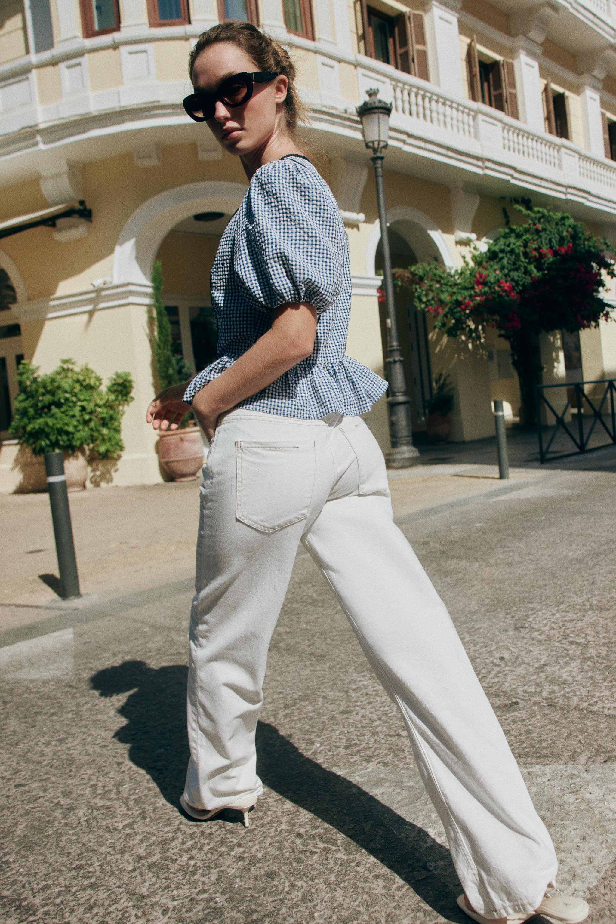 V-neck blouse with short balloon sleeves with elastic cuffs. A-line hem. Front button closure. | Zara US