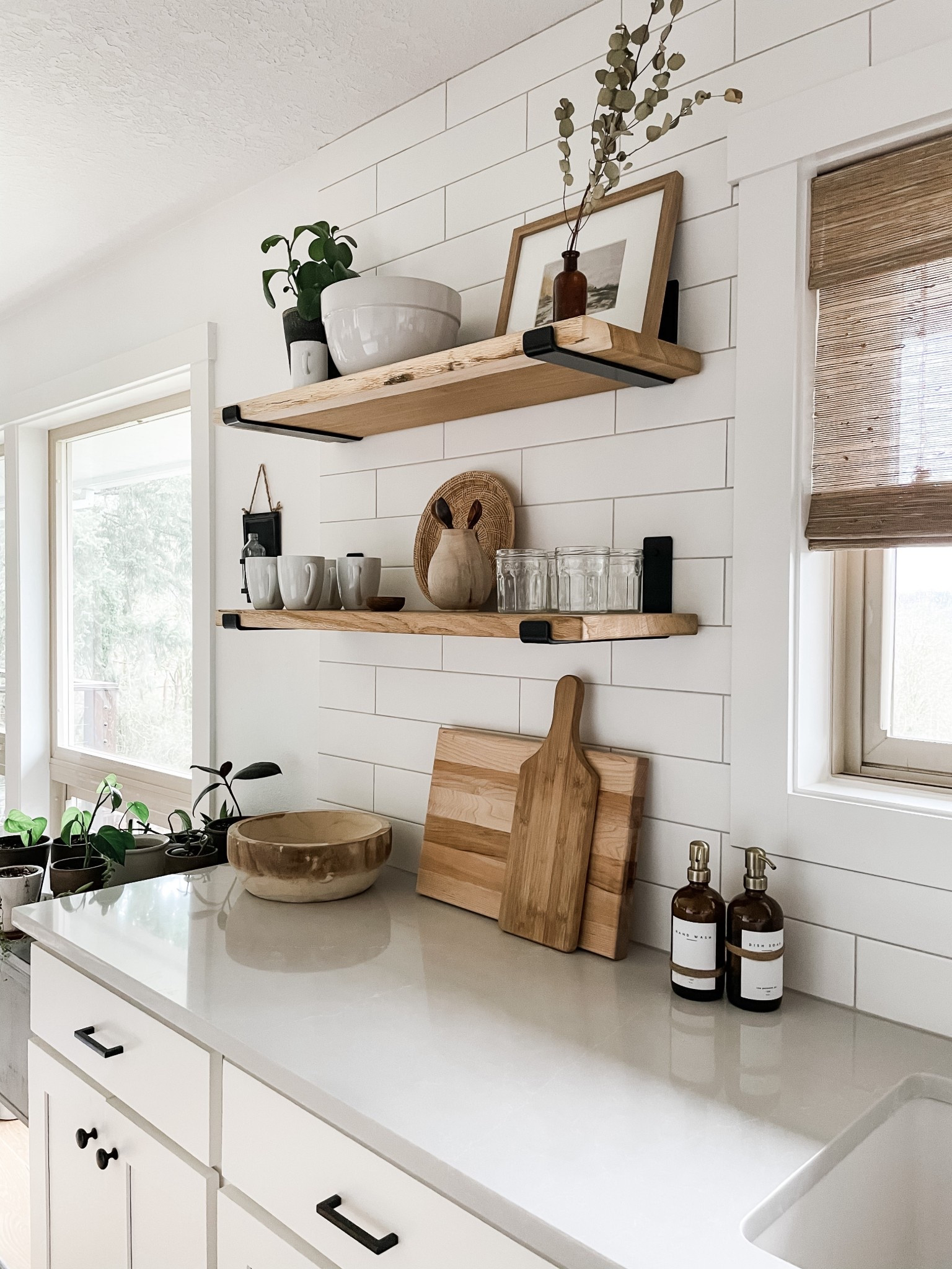 Throwback to a simple clean yet cozy kitchen. Added warm, wet, cutting boards, Amber soap, bottles, thrifted basket trays, and woven wood shades. 💛

#LTKSeasonal #LTKHome