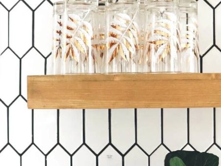 White Ceramic Tile Backsplash with wooden floating shelves (on sale) with vintage gold tumblers. Kitchen Shelving Ideas #floatingshelves #kitchenshelves #openshelves

#LTKhome #LTKsalealert