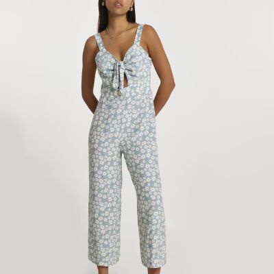 Blue sleeveless floral front tie jumpsuit | River Island (UK & IE)
