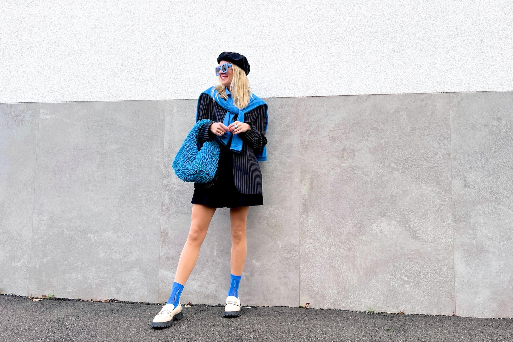 Everything Blue. Fashion Blogger Girl by Style Blog Heartfelt Hunt. Girl with blond hair wearing a beret, blue sunglasses, blue sweater, pinstriped blazer, blue top, black skirt, blue statement bag, blue socks and chunky loafers. #colorfuloutfit #colorfulstyle #colorfulfashion #colorfullooks #fashionfun #cutefalloutfit #fallfashion2022 #falllookbook #fitcheck #dailylooks #dailylookbook #contentcreator #microinfluencer
