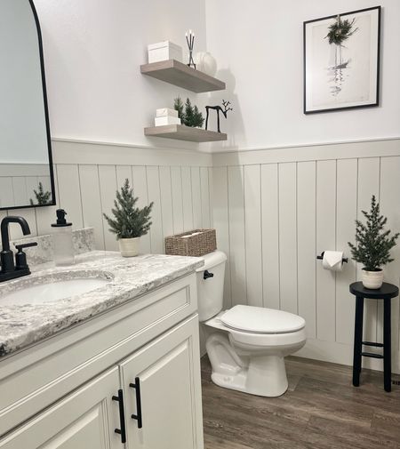 Bathroom views with touches of evergreen for the holidays  

Bathroom / hand towels / arch mirror / faux plants / floating shelves / vintage wall art / black faucet / moen / everlasting candle / vertical shiplap / soap dispenser / bathroom fixtures / holiday decor 

#LTKfindsunder50 #LTKhome #LTKHoliday