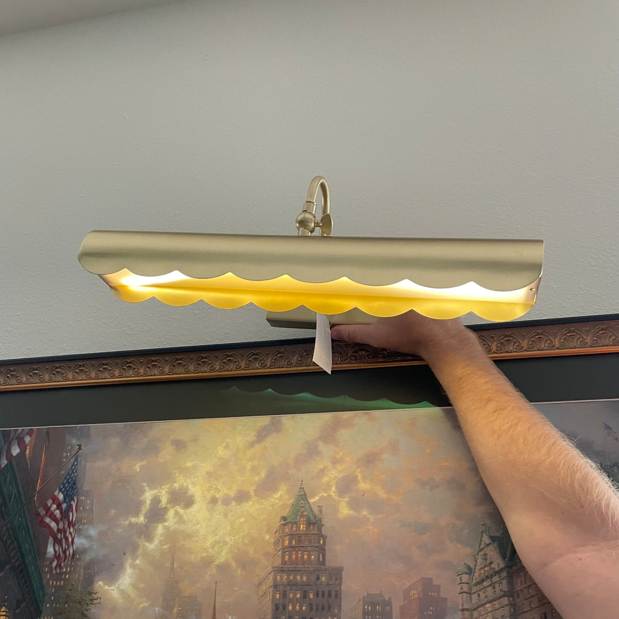Gold scallop edge picture sconce light. Battery operated and only $50. An easy way to add elegance to any room  

#LTKHome