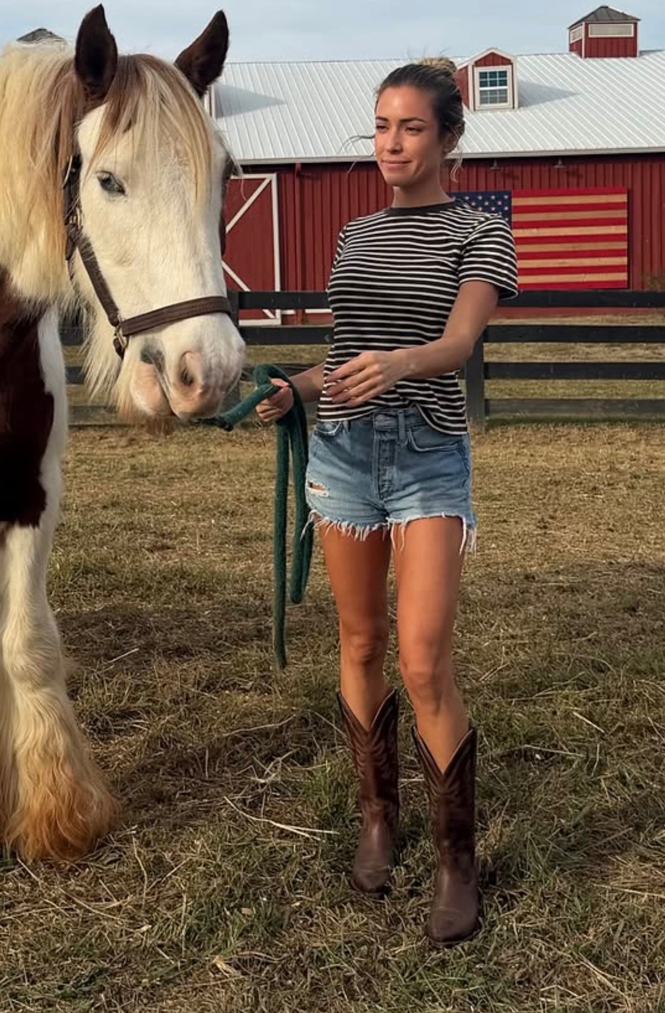 Kristin Cavallari striped crewneck short sleeved T-shirt, cut off distressed denim shorts, leather cowboy boots