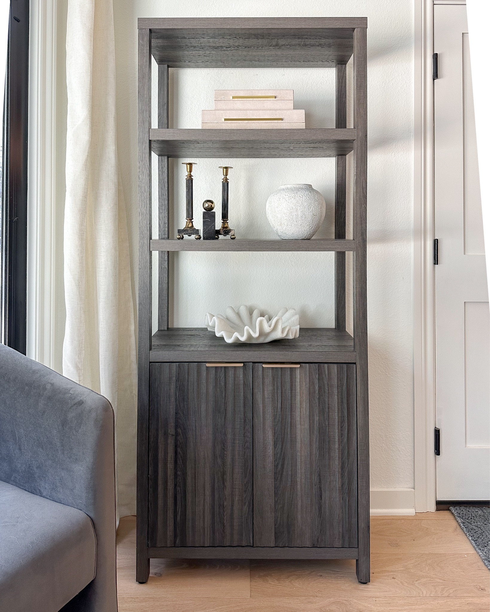 Fluted bookcase storage cabinet and decor! Found a great less expensive option for my ruffled stone bowl! Candlesticks are vintage 🥰 

#LTKhome #LTKfindsunder50 #LTKstyletip