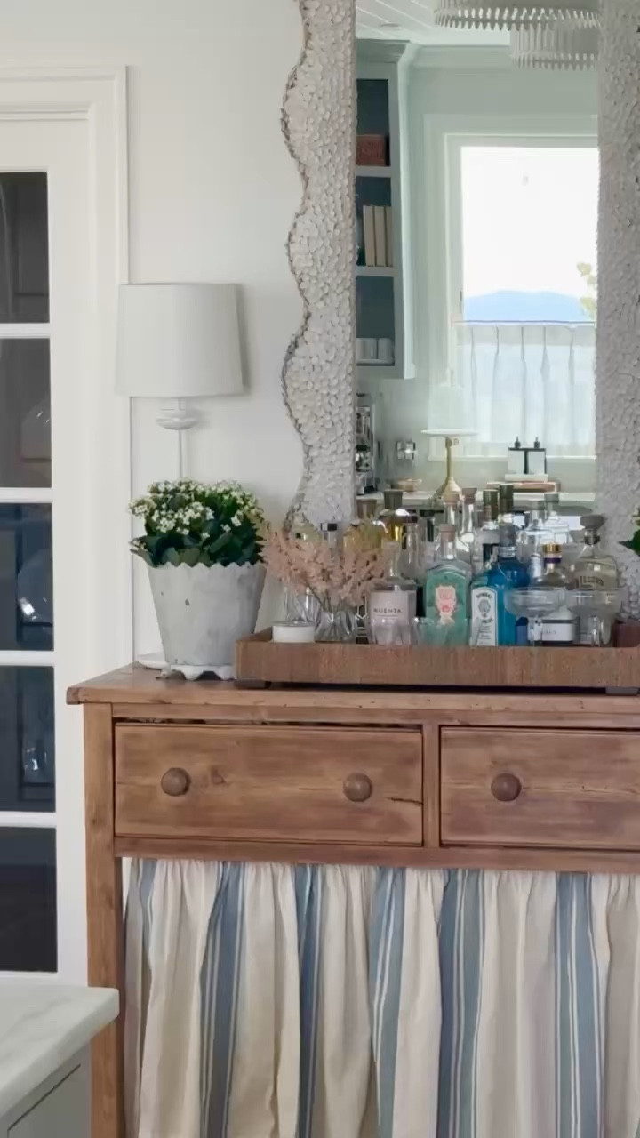 I love this little entryway table with the custom curtain and the little bar area on top! Decor tip: buy nice alcohol in a color palette to make a pretty display! Table is old 

 

#LTKOver40 #LTKHome