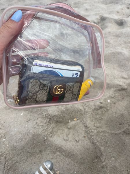 I use these clear toiletry bags from Amazon to store my phone and wallet on the beach so they dont get wet or sandy