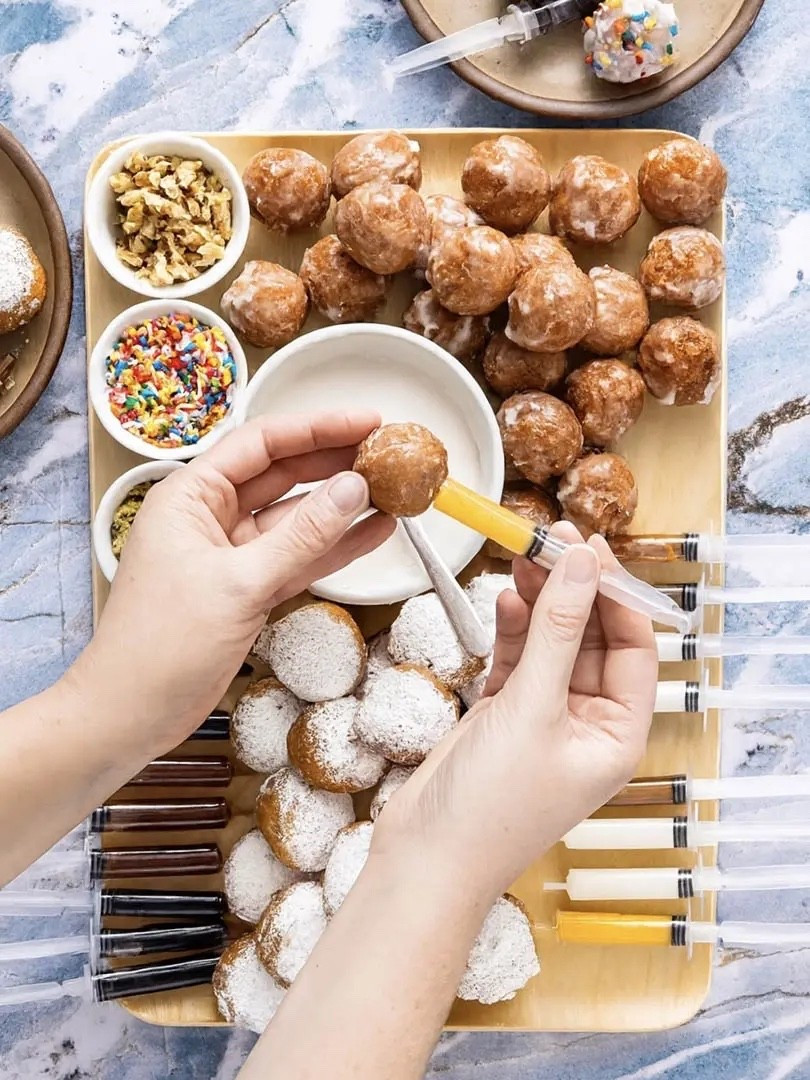 Christmas App Idea 

Ingredients
* 24-30 powdered or glazed donut holes
* Assorted fillings: strawberry jam, Nutella, lemon curd, cream cheese, caramel
* Assorted toppings: powdered sugar, sprinkles, chopped nuts
Instructions 
* Arrange bowls of toppings neatly on the board. 
* Place donuts on the board, making distinct piles of each type of donut. 
* Fill food-safe syringes or squeeze bottles with jams or fillings of your choice. 
* Invite guests to inject, dip, and decorate their own sufganiyot. 

#LTKHoliday #LTKSeasonal #LTKHome