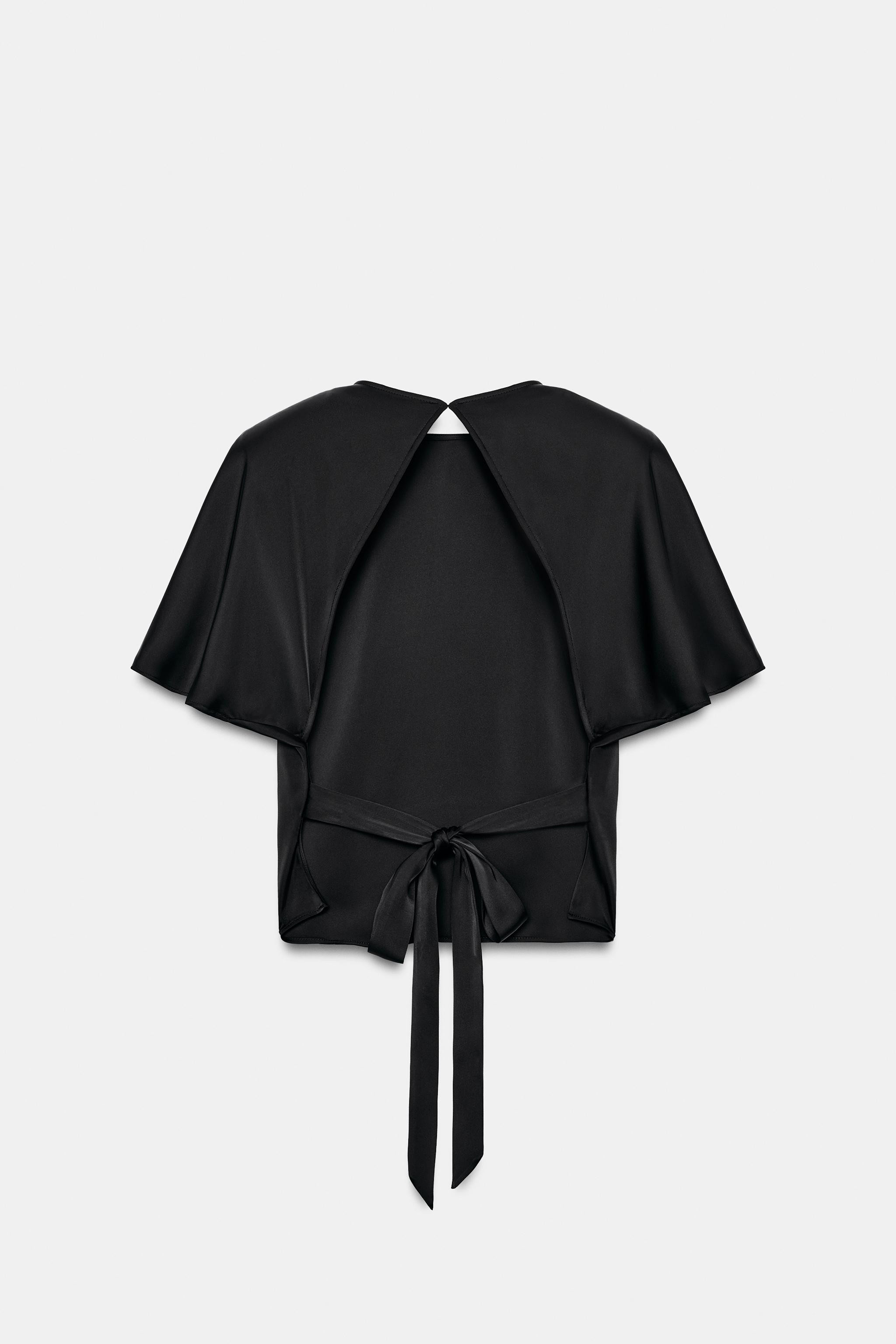 Top made of satin fabric. Features a round neck and short sleeves with shoulder pads. Open back d... | Zara US