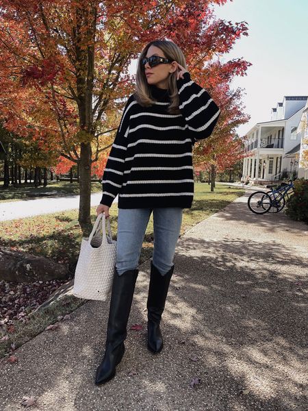 Striped sweater / tall boots / woven bag 