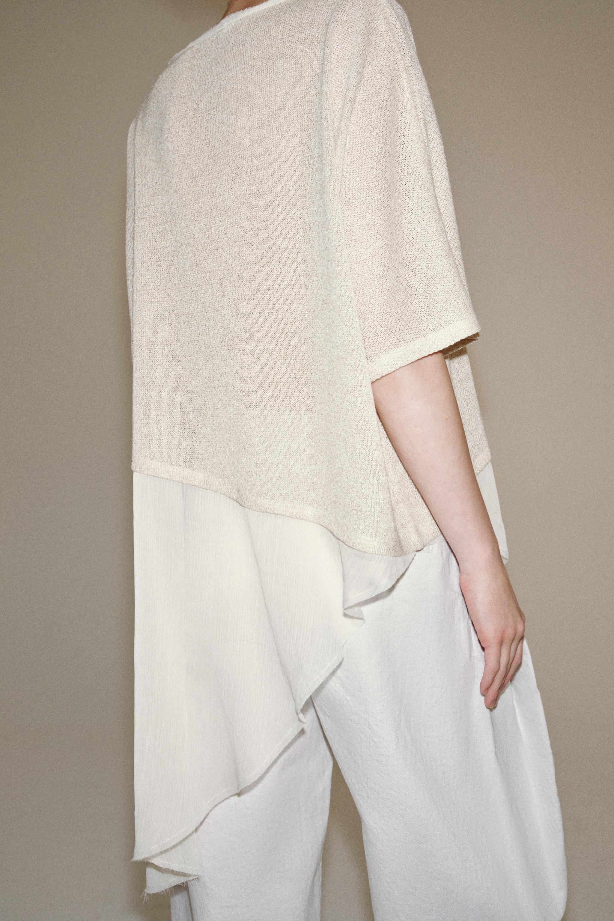 Model height: 176 cmCape-style top with a round neck and short sleeves. Featuring contrast fabric... | Zara UK