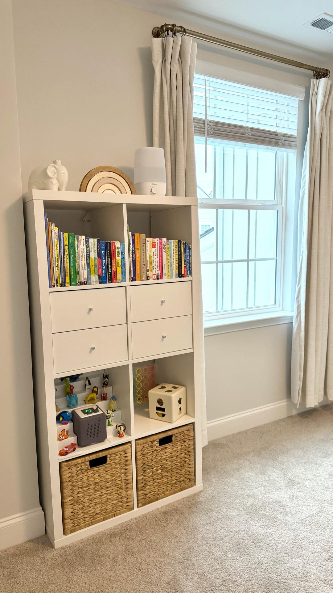I promise this tiny tweak has changed our playroom and our car rides 🤍

This tiered magnetic organizer fits right into a cube storage unit and looks like a custom built-in for our Toniebox + Tonies — with space for every character and even the charger. No more toys scattered everywhere. 🙌

We started using the Toniebox audio system around age 2 and it’s been SUCH a win — simple for toddlers to use independently and perfect for screen-free listening on repeat. You can play music, stories, and even upload your own voice or stories with Creative-Tonies, which makes travel and bedtime feel special and calm.

In this reel I show exactly how I pack up a small set of Tonies for trips — it’s one of our favorite toddler travel hacks because it keeps him happy, engaged, and entertained without a tablet. ✈️🚗

If you’re building a home that’s calm + organized for little ones — and want screen-free activities that actually work — this setup is a keeper 🤍

✨SAVE this for toy organization inspo + quiet play ideas!
✨SHARE with a mom who needs some new ideas
✨Comment TONIE for links 🤍

@tonies.us 
#Toniebox #Tonies #ToyOrganization #PlayroomOrganization #ScreenFreeKids #ToddlerMomLife #ScreenFreePlay #ToddlerTravel #CarRideWithKids #QuietPlayIdeas #OrganizedHome #ToddlerActivities #MomLifeHacks #TravelWithKids ad

#LTKmomlife #LTKKids #LTKBaby