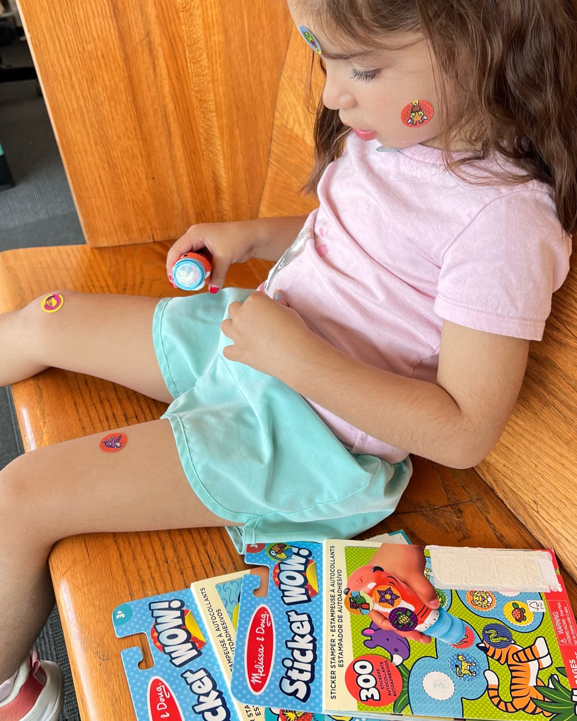 StickerWow from Melissa & Doug keeps her entertained at her brother’s after school activities!! And then ends up like this  