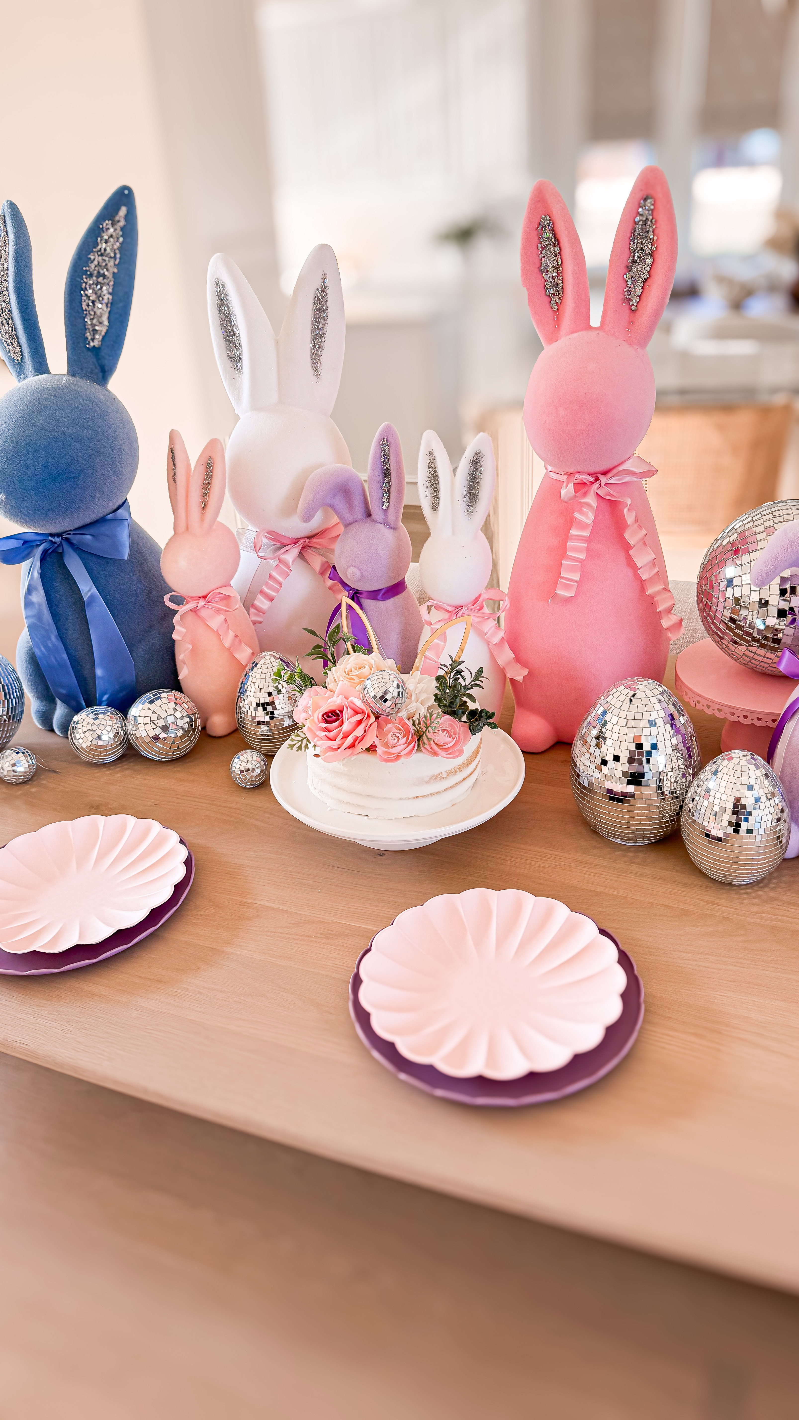 Whimsical Easter tablescape idea ✨ Flocked bunnies, disco balls, and a little sparkle—because why not?! ✨🐰 I’ve been collecting flocked bunnies for years, and this time, I gave them a little DIY glow-up with glittery ears. I lined the table with them, added some disco magic, and even found these cute disco eggs at Walmart! It’s simple, fun, and definitely a conversation starter. Would you ever do a whimsical Easter table like this? Or do you keep it more traditional? 👀 Kids Easter - Easter tablescape - flocked Easter bunnies - disco eggs - disco balls - Easter party 
