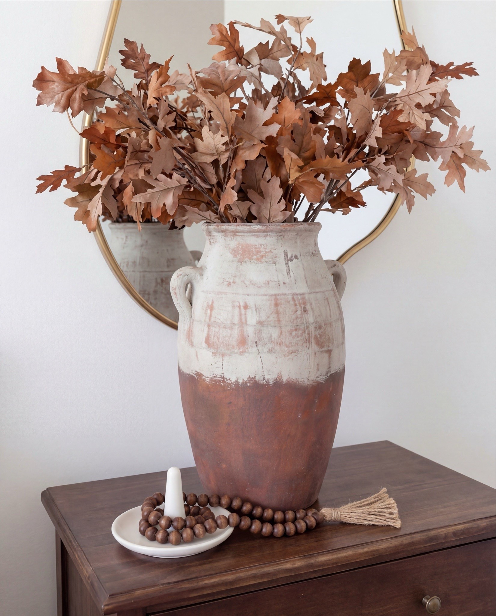 Shop the Look:
• White upholstered arched headboard bed
• White cotton duvet cover + pillow shams
• Green vintage-style area rug (distressed pattern)
• Brown chunky knit throw blanket
• Dark wood nightstands with cane doors
• White ceramic table lamp (round base)
• Brass wall sconces with glass shades
• Organic shape gold wall mirrors
• Black and beige abstract framed wall art
• Green geometric throw pillows
• Upholstered brown bench (channel tufted)
• Dark wood dresser with brass pulls
• Round ivory accent chair
• Cream throw blanket (soft knit texture)
• Tall brass floor lamp with white shade
• Decorative book stack (neutral tones)
• Small wood decorative box
• Brass round tray
• White pedestal decorative bowl
• Marble candle holders with brass rings
• Taper candles (ivory)
• Large ceramic vase with dried stems



#LTKSaleAlert #LTKHome