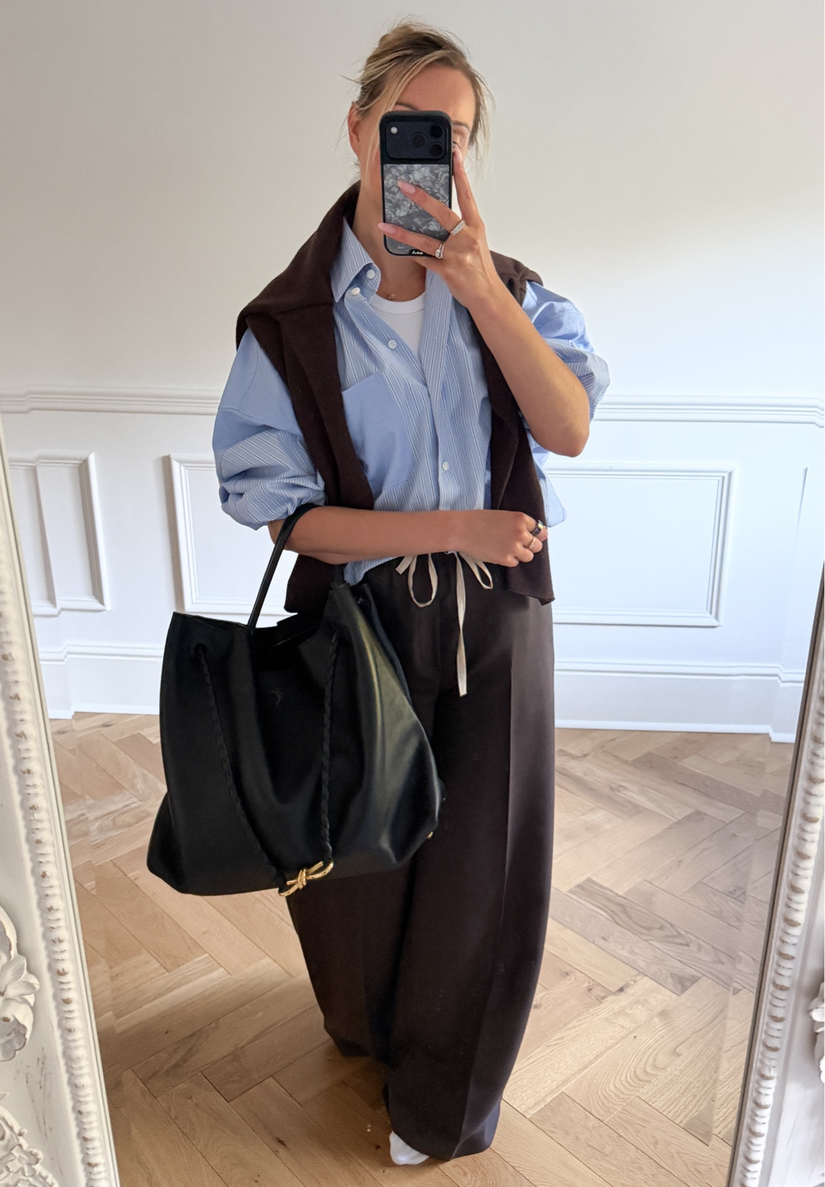 Super comfy layered travel outfit with drawstring trousers, an oversized pinstripe blue shirt (wearing size XS) and large Bottega Andiamo black bag. 

#LTKootd #LTKTravel #LTKdayinmylife
